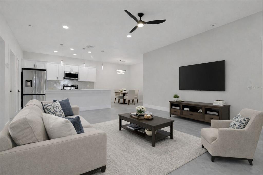 4501 15th Street Southwest Lehigh Acres, FL 33973 - Photo 4 of 40 a living room with furniture and a flat screen tv