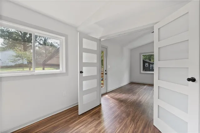 wooden floor in an empty room with a window