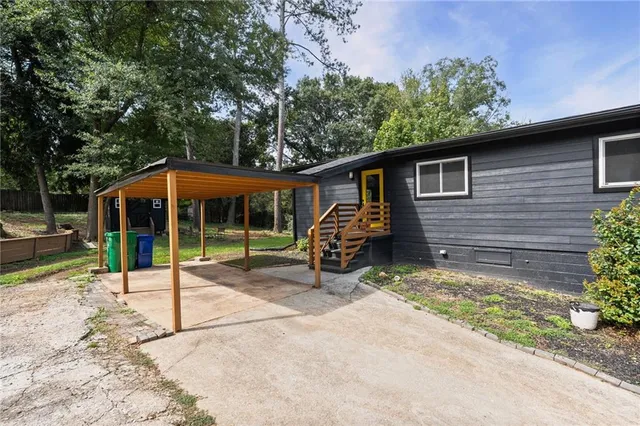 a view of a house with a yard and furniture