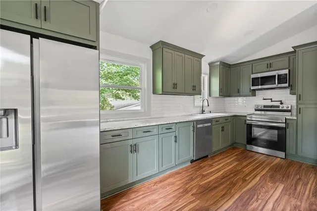 a kitchen with a sink stove and refrigerator