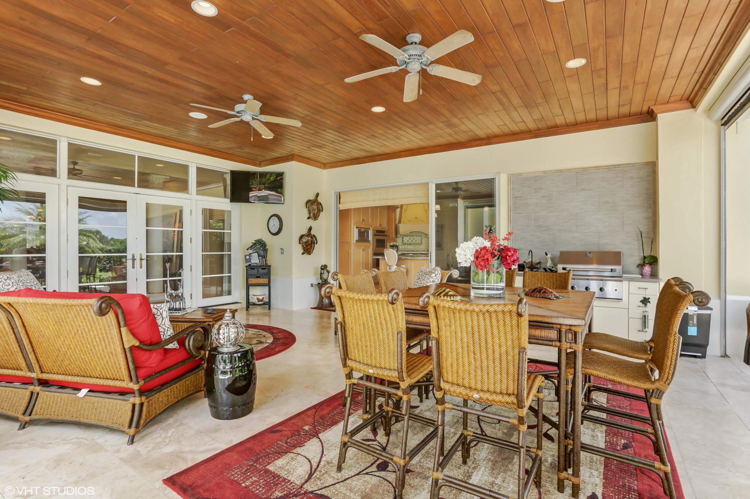 119 Terrapin Trail Jupiter, FL 33458 - Photo 13 of 41 a living room with furniture a chandelier and a dining table