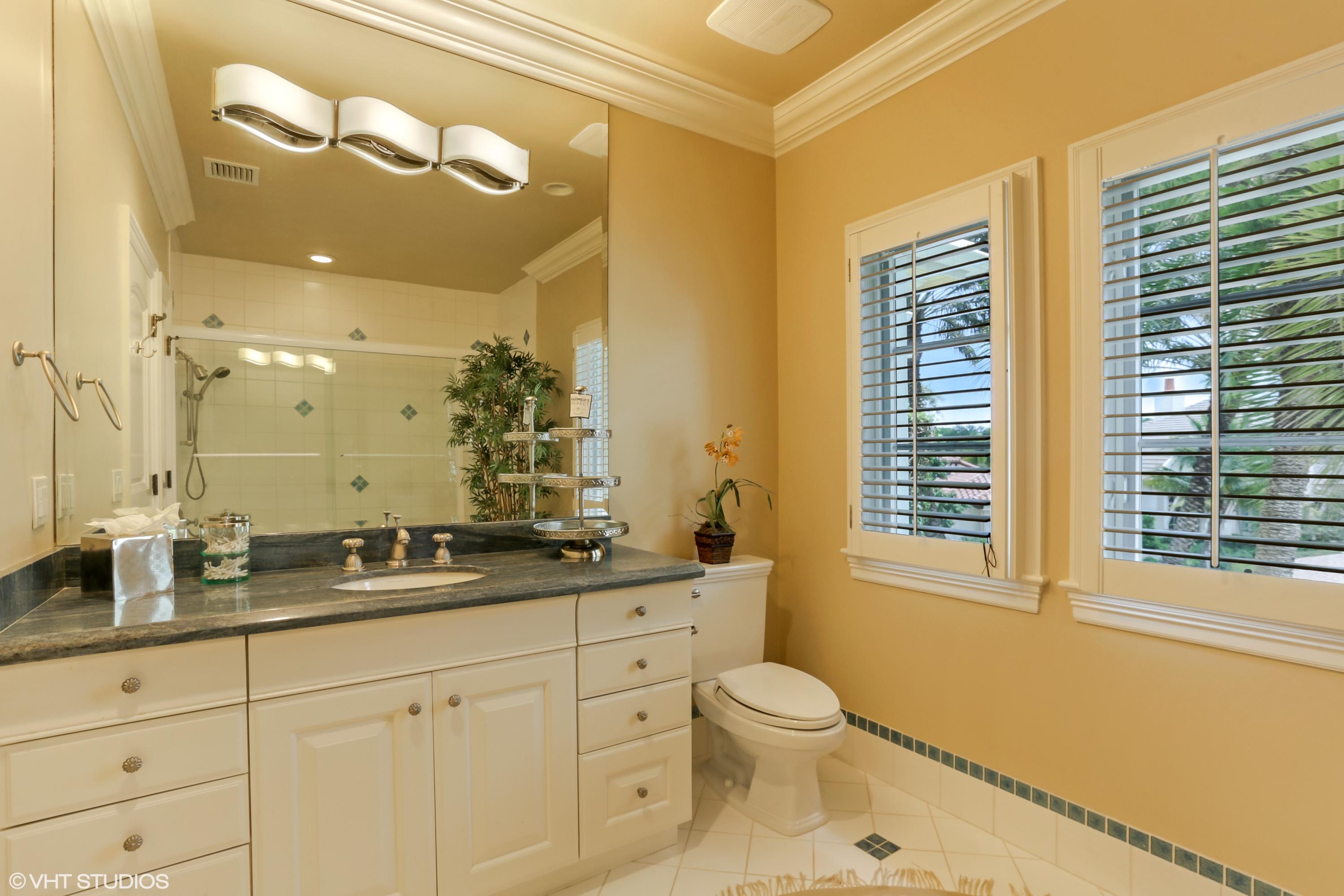 119 Terrapin Trail Jupiter, FL 33458 - Photo 20 of 41 a bathroom with a granite countertop sink mirror vanity and a toilet