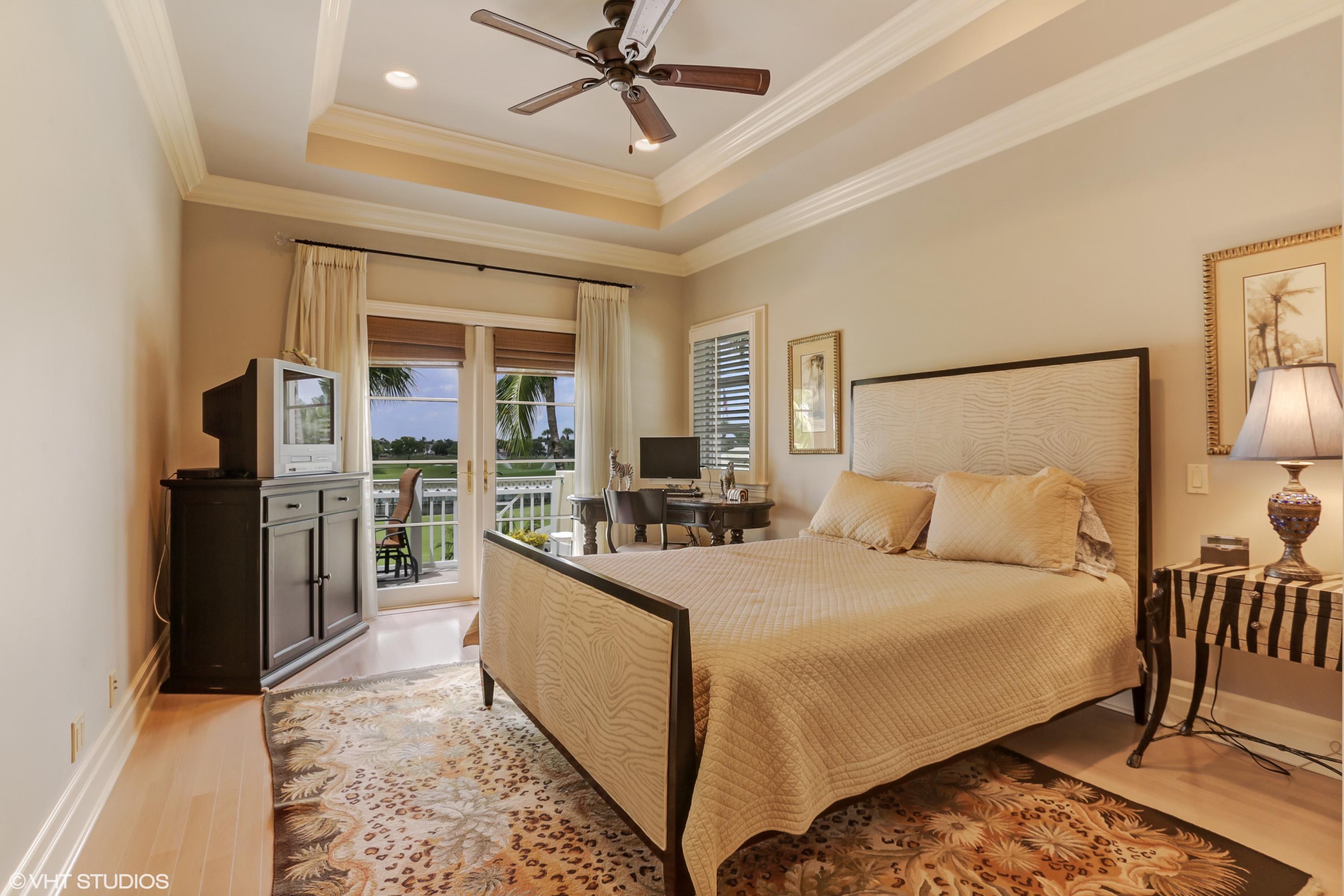 119 Terrapin Trail Jupiter, FL 33458 - Photo 25 of 41 a large bedroom with a bed and a chandelier