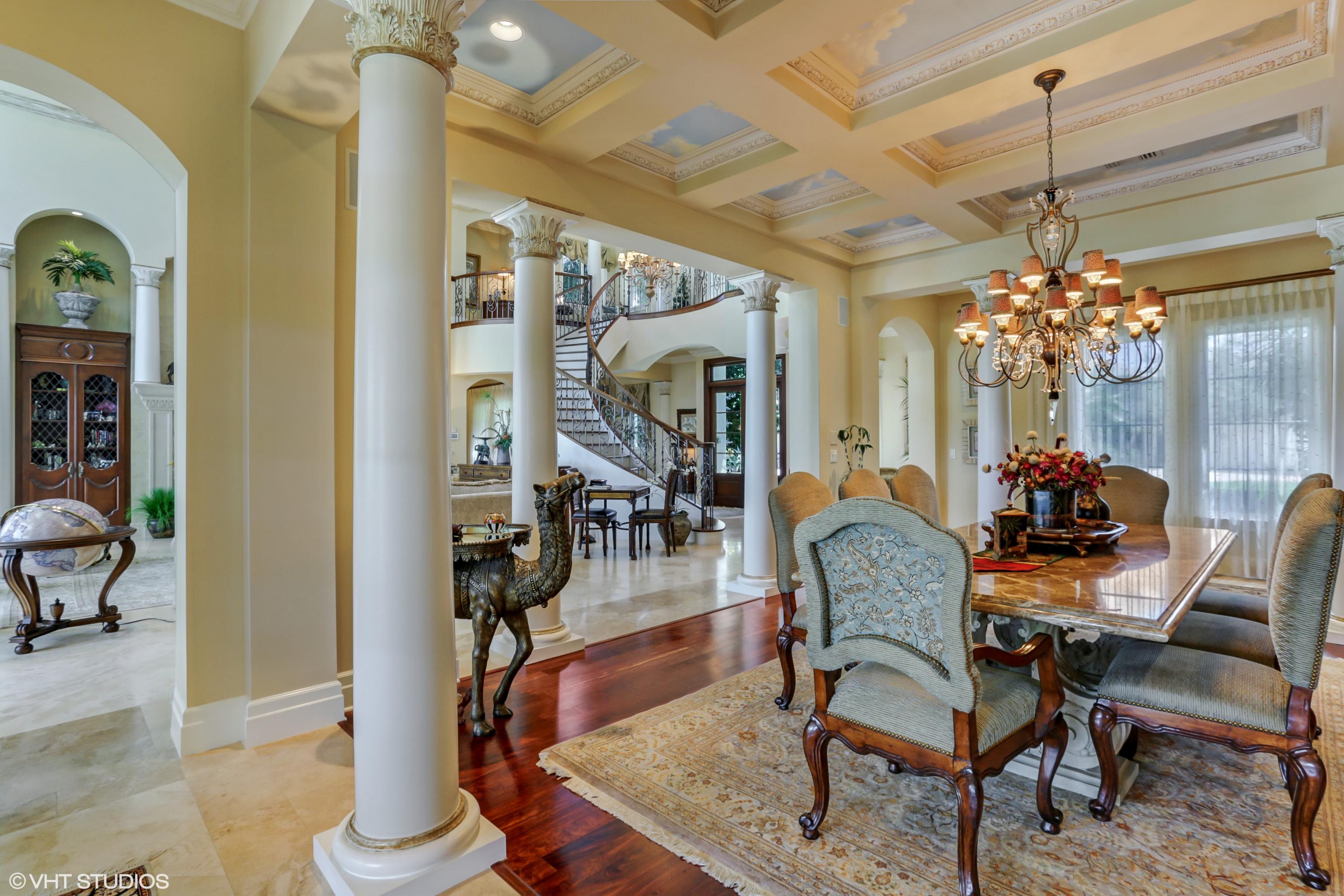 119 Terrapin Trail Jupiter, FL 33458 - Photo 33 of 41 a dining room with furniture a chandelier and wooden floor