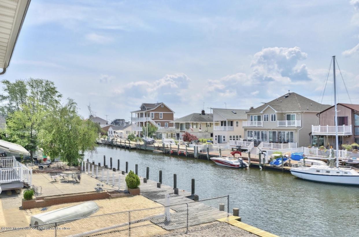 719 Drum Point Road Brick, NJ 08723 - Photo 1 of 37 a view of a lake with a large house
