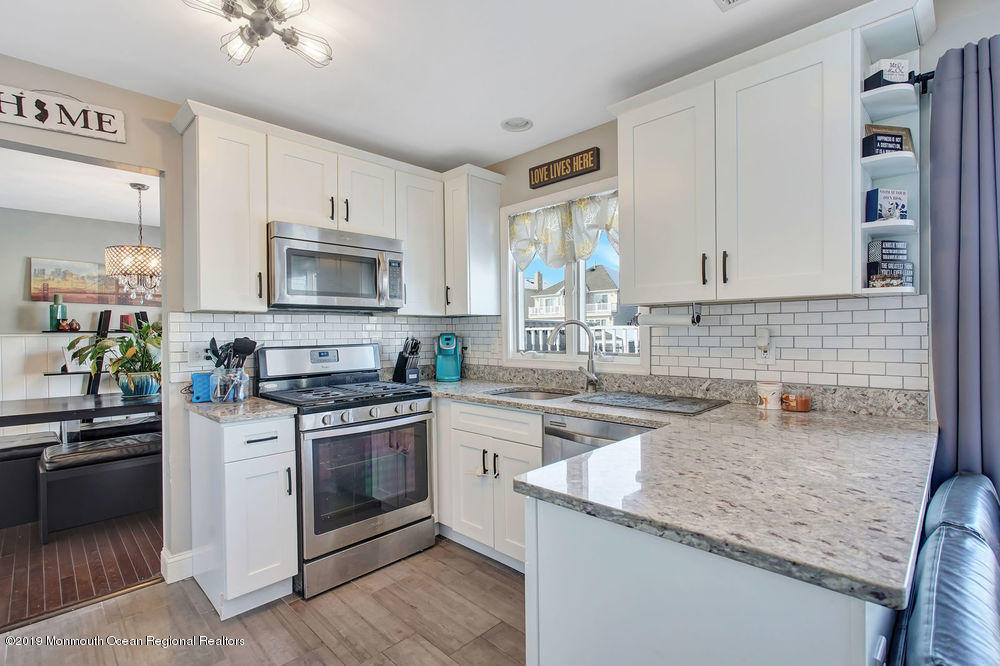 719 Drum Point Road Brick, NJ 08723 - Photo 11 of 37 a kitchen with a sink stove top oven and microwave