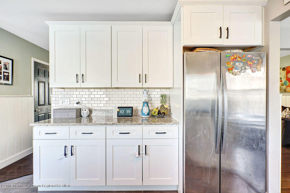 719 Drum Point Road Brick, NJ 08723 - Photo 12 of 37 a kitchen with white cabinets and refrigerator
