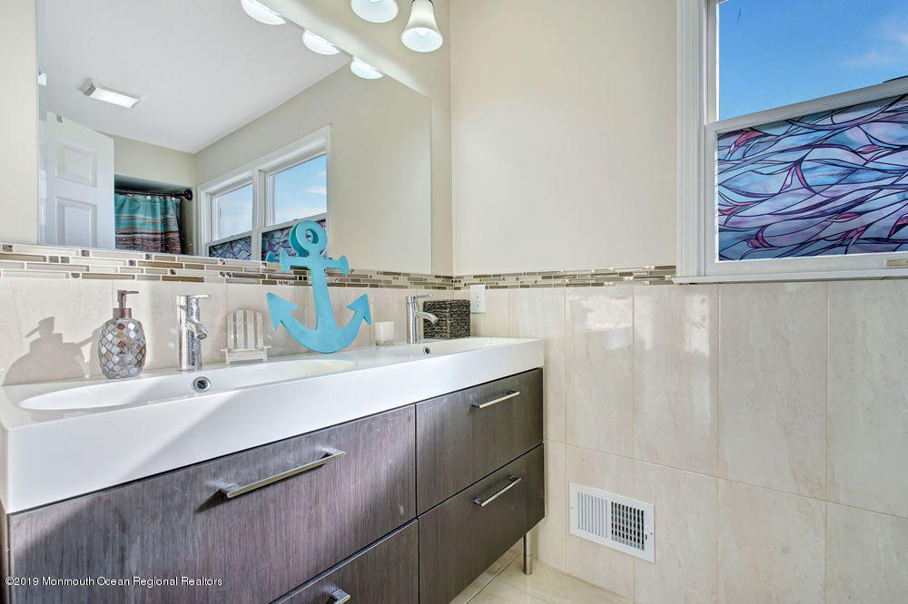 719 Drum Point Road Brick, NJ 08723 - Photo 27 of 37 a kitchen with a sink cabinets and window