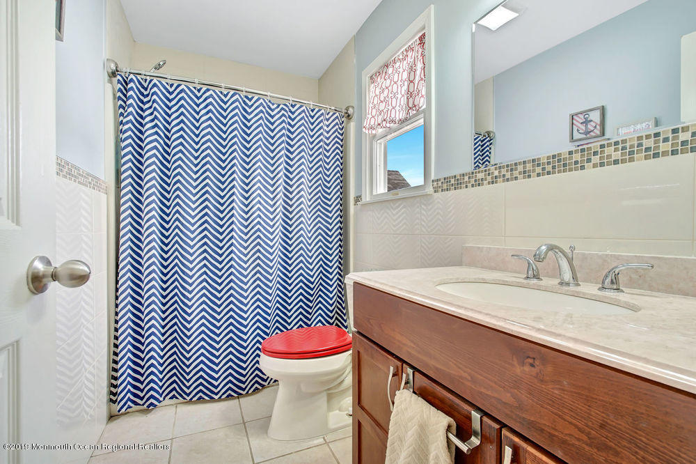 719 Drum Point Road Brick, NJ 08723 - Photo 32 of 37 a bathroom with a sink and a toilet