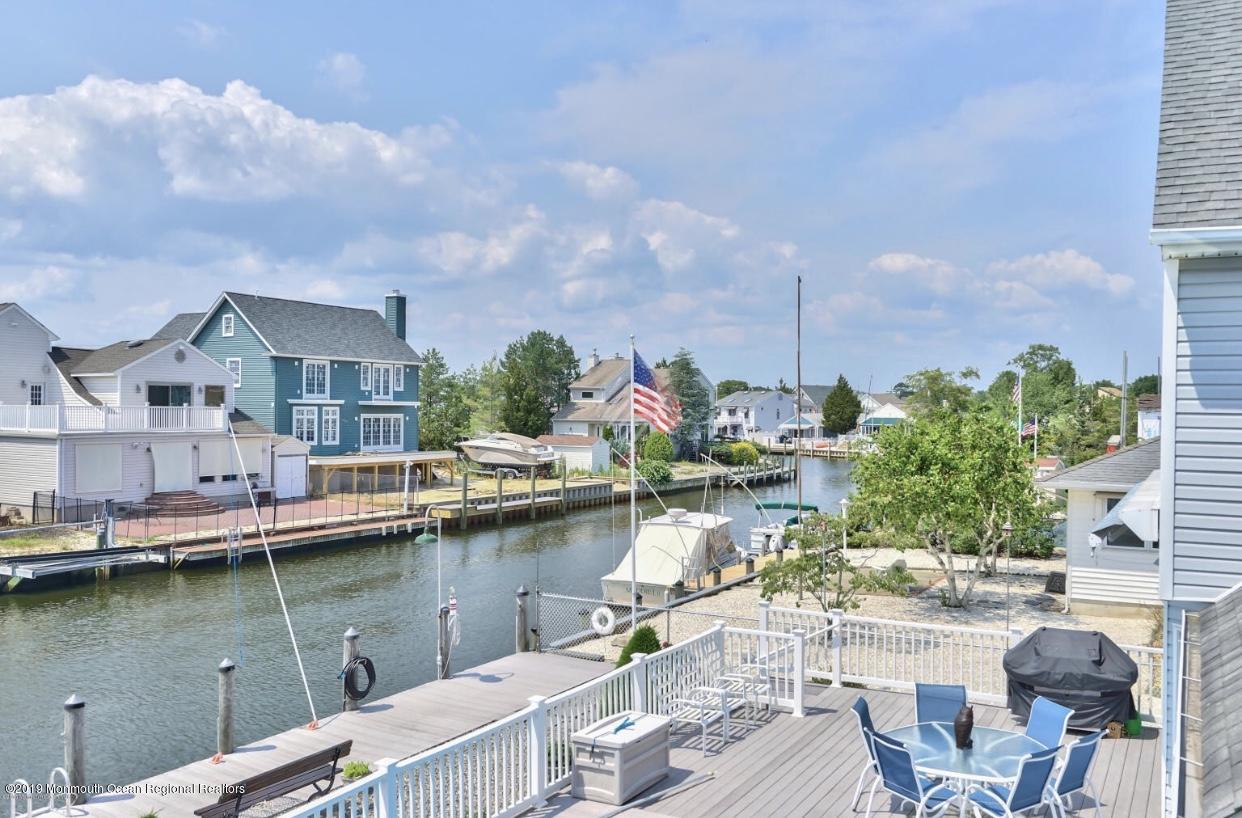 719 Drum Point Road Brick, NJ 08723 - Photo 33 of 37 a view of a lake with a house swimming pool and outdoor space