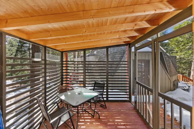 a balcony with table and chairs