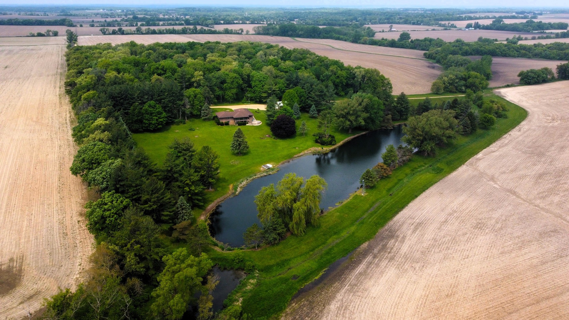 an aerial view of a house with a yard and outdoor seating