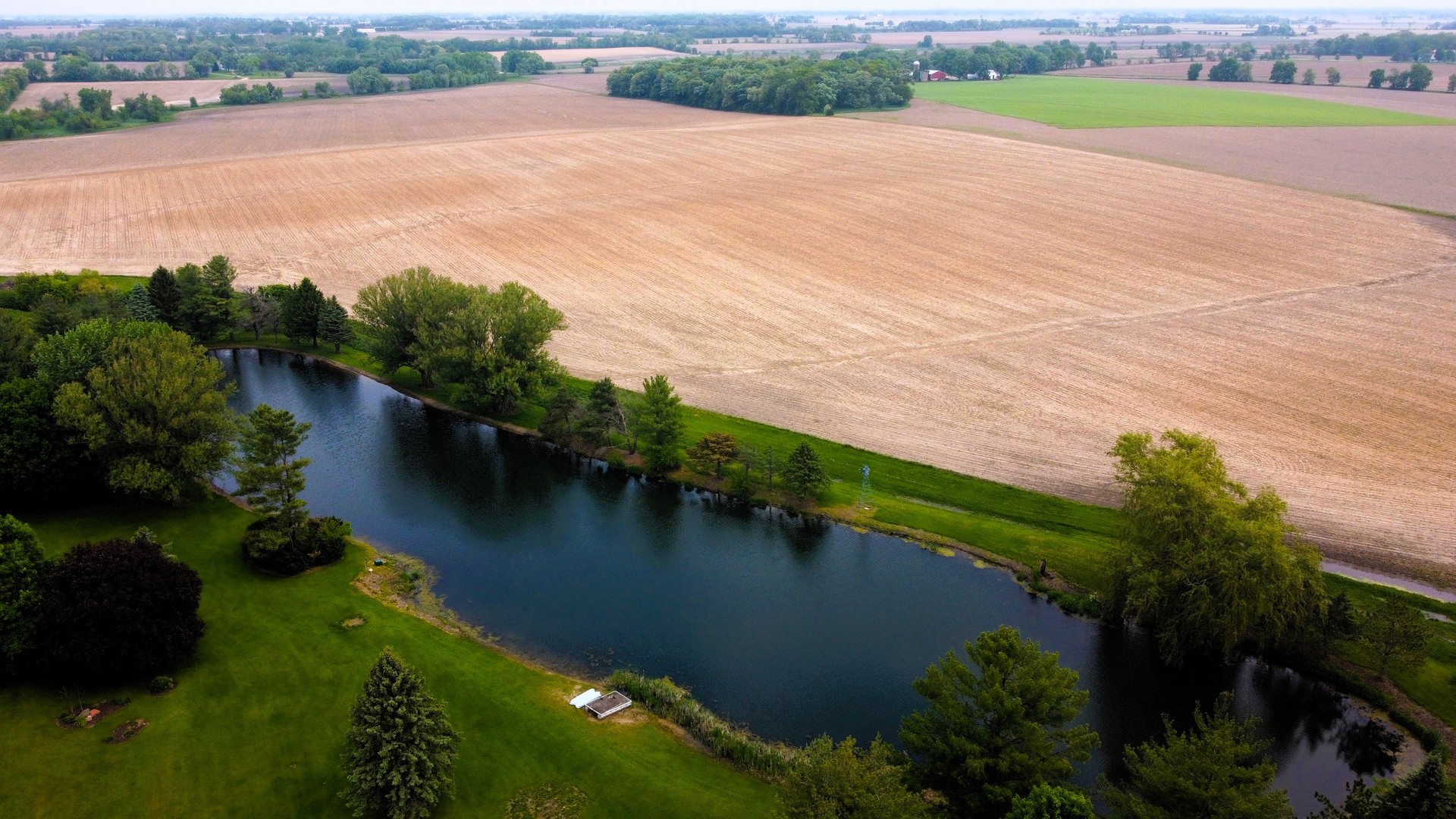 17445 Livingston School Road Caledonia, IL 61011 - Photo 2 of 33 an aerial view of lake residential house with outdoor space and trees around