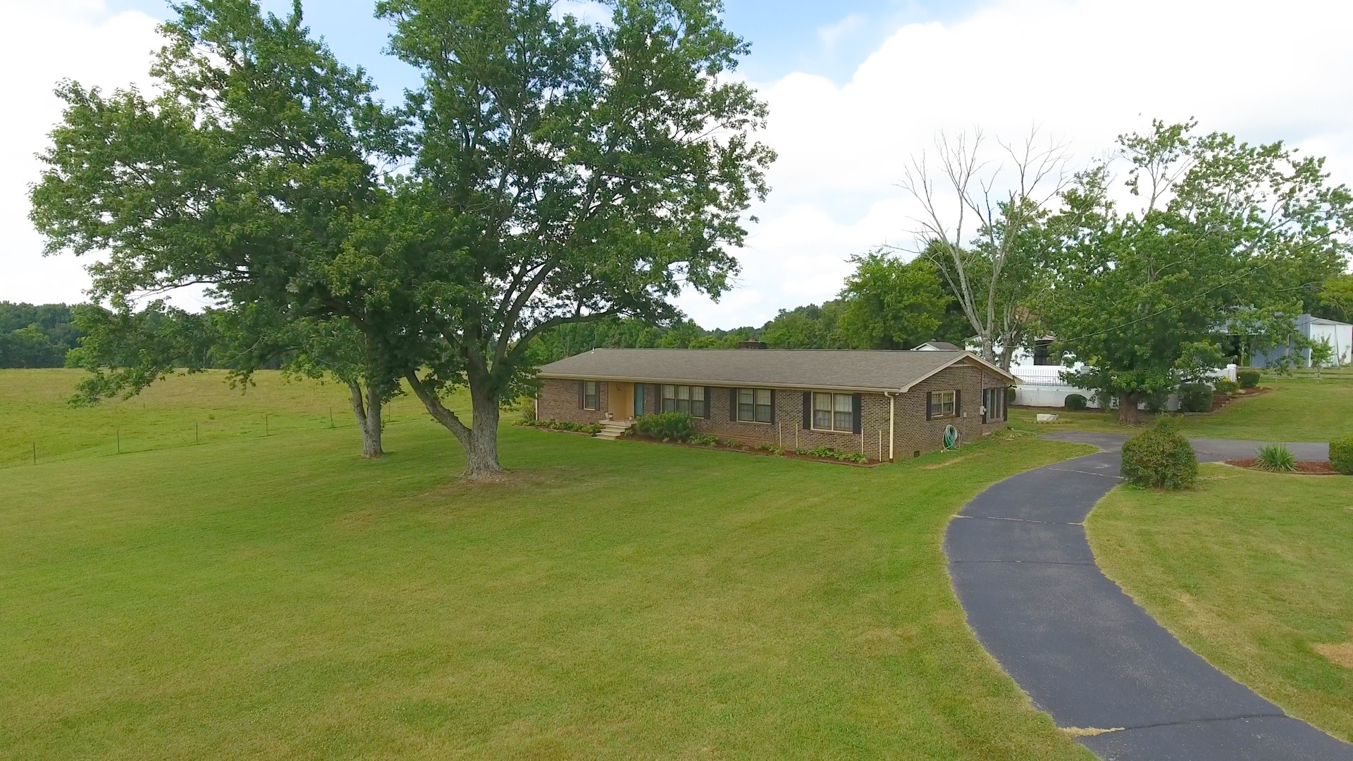 208 Old Quick Road Fayetteville, TN 37334 - Photo 50 of 51 a view of a house with a big yard potted plants and large tree