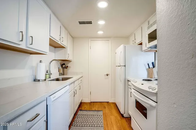 a kitchen with a sink and cabinets