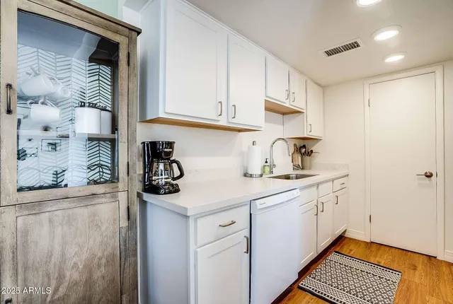 a kitchen with kitchen island a sink appliances and cabinets