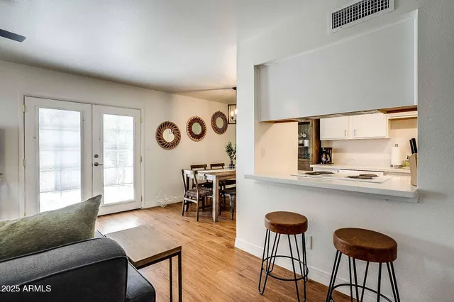 a living room with furniture and wooden floor