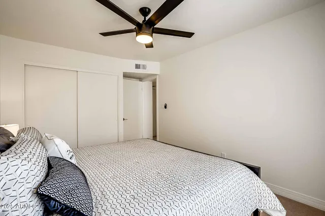 a bedroom with a bed and wall painting