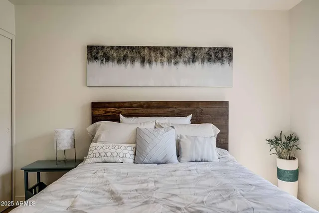 a bedroom with a bed a desk and chair