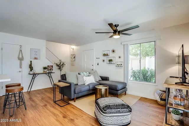 a living room with furniture a rug and a flat screen tv
