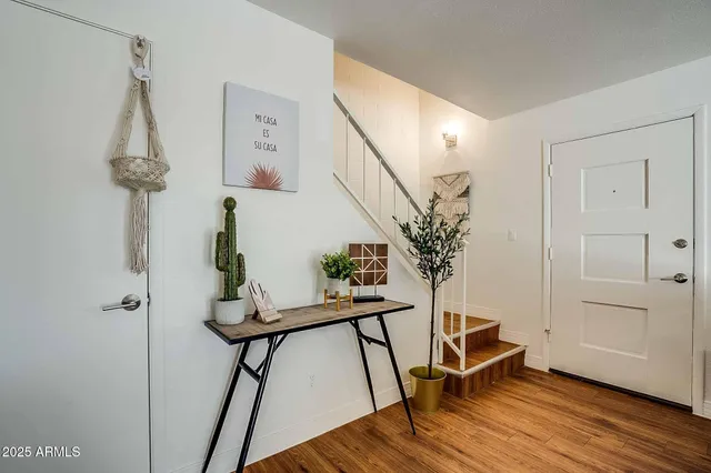 a view of a room with wooden floor and bench