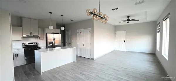 a kitchen with a refrigerator and a sink