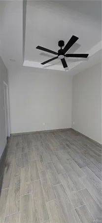 a view of a room with wooden floor