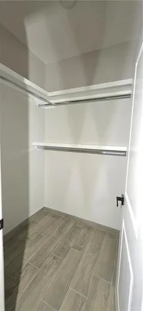 a bathroom with a sink a toilet a mirror and shower