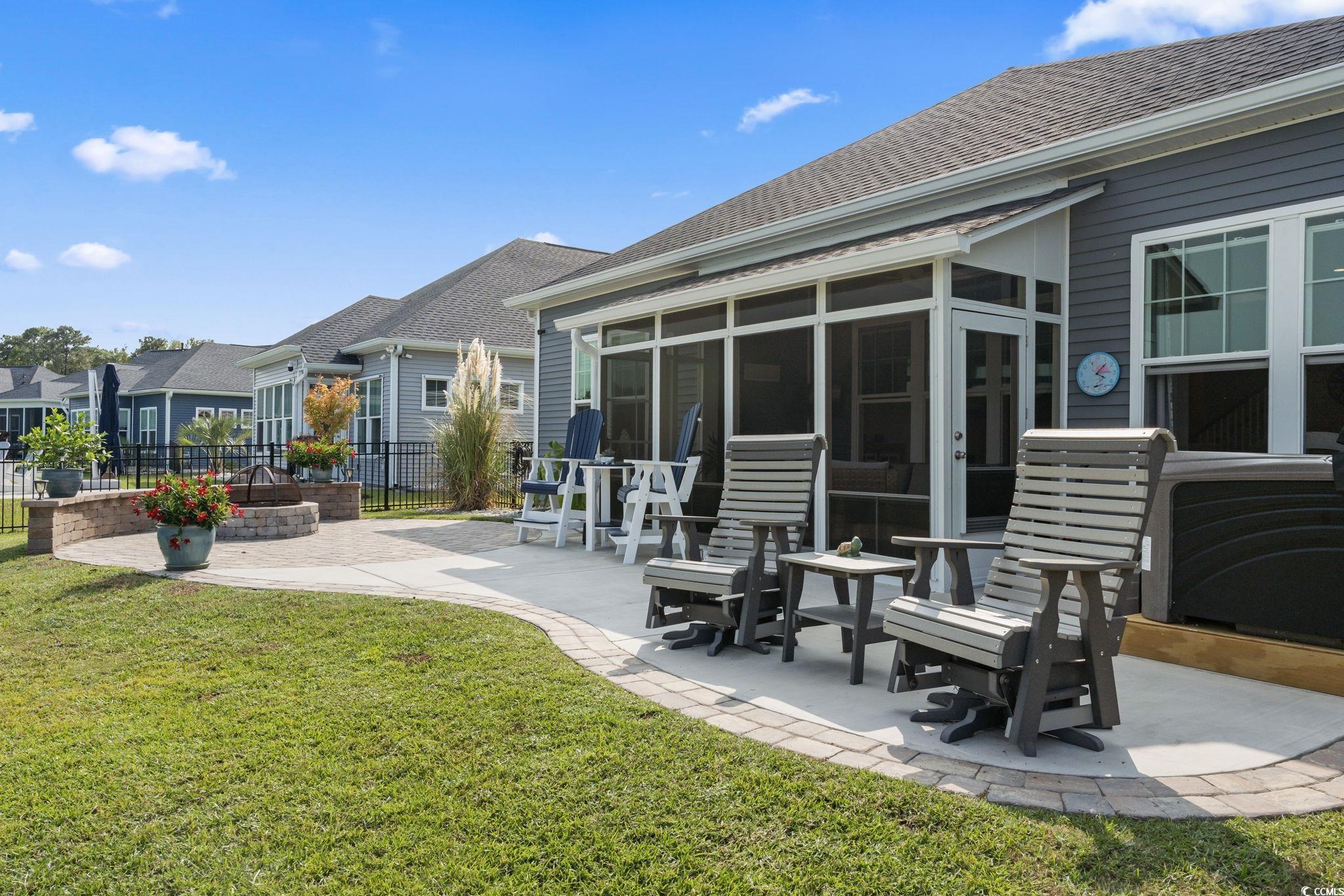 389 Bumble Circle Murrells Inlet, SC 29576 - Photo 23 of 40 Back of house with a patio, a sunroom, and a lawn