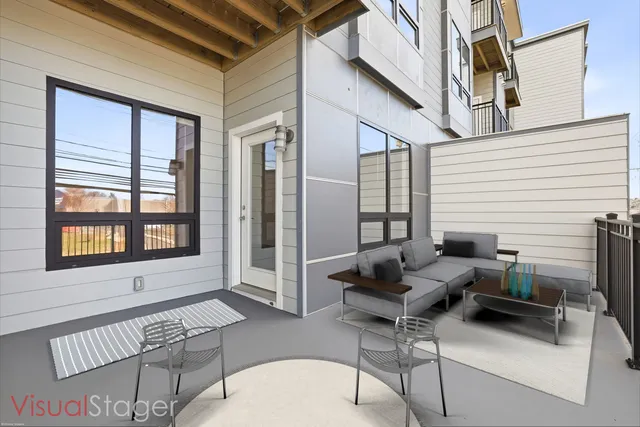 a balcony with furniture and a potted plant