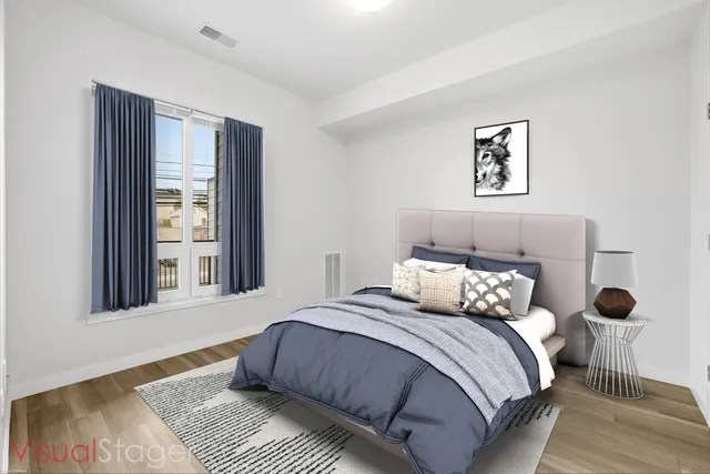 a bedroom with a large bed and a window