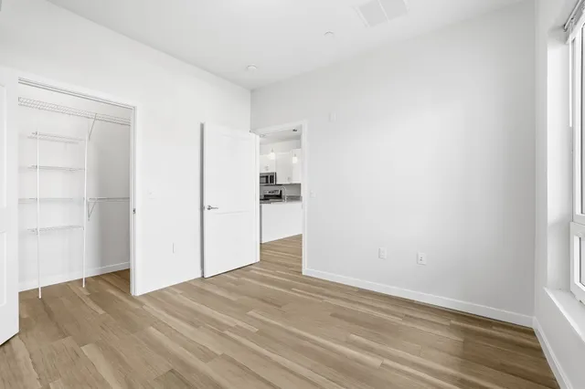 a view of a kitchen with wooden floor and a sink