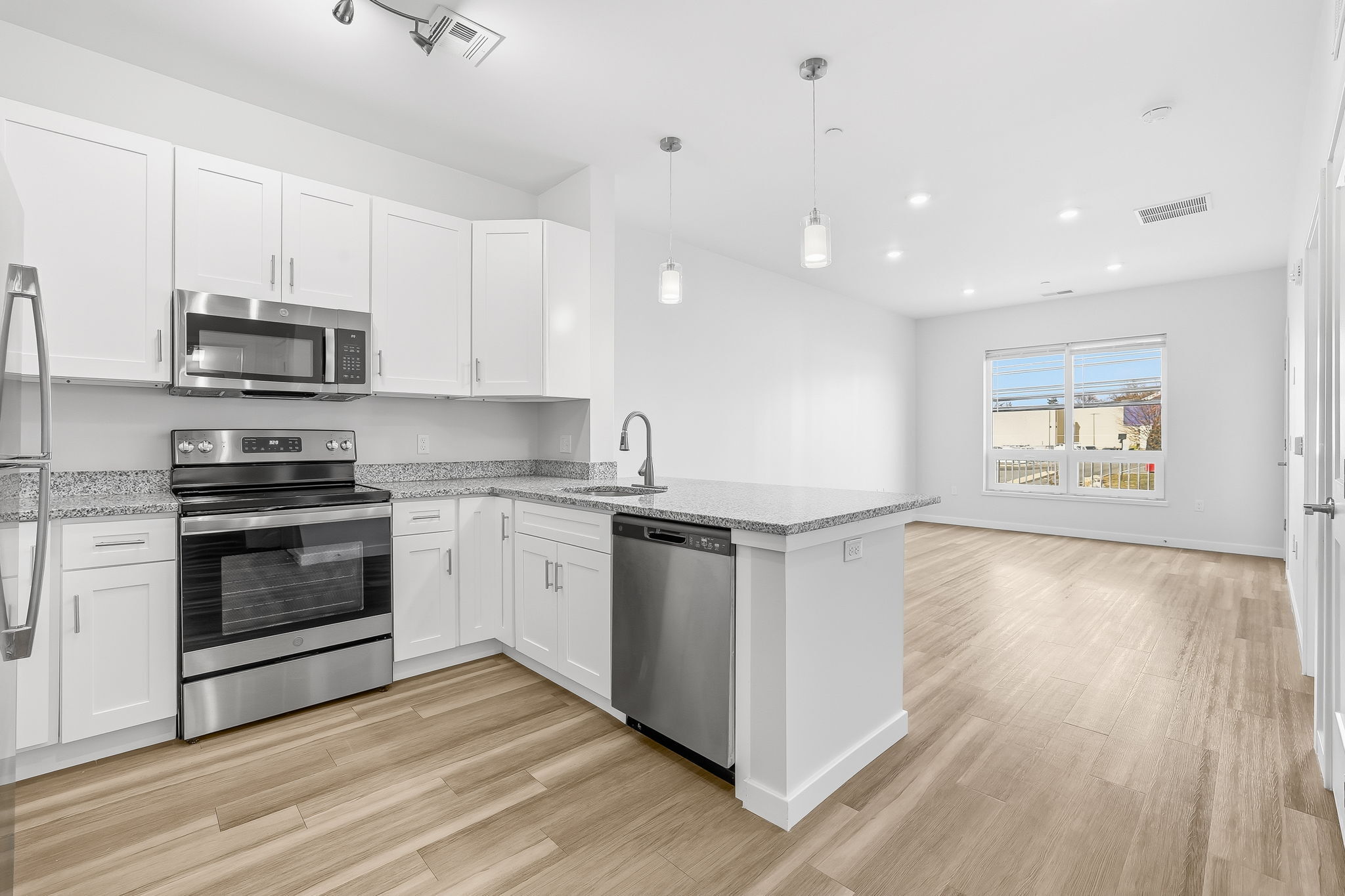 71 Connecticut Avenue, Unit 205 Norwalk, CT 06850 - Photo 9 of 17 a kitchen with stainless steel appliances a stove a sink and a refrigerator