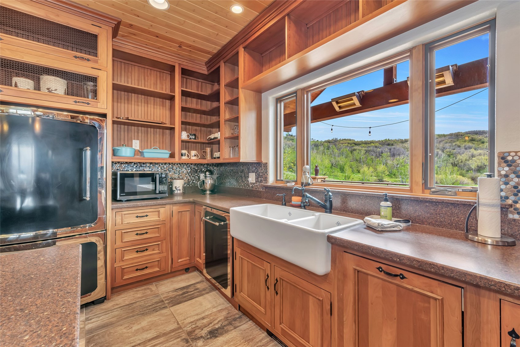 31485 Deerwood Ranch Road Steamboat Springs, CO 80487 - Photo 27 of 49 a kitchen with a sink stove and cabinets