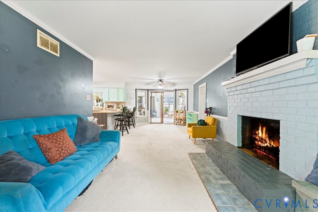 7141 Barkbridge Road Chesterfield, VA 23832 - Photo 13 of 44 Living area with crown molding, a fireplace, carpe