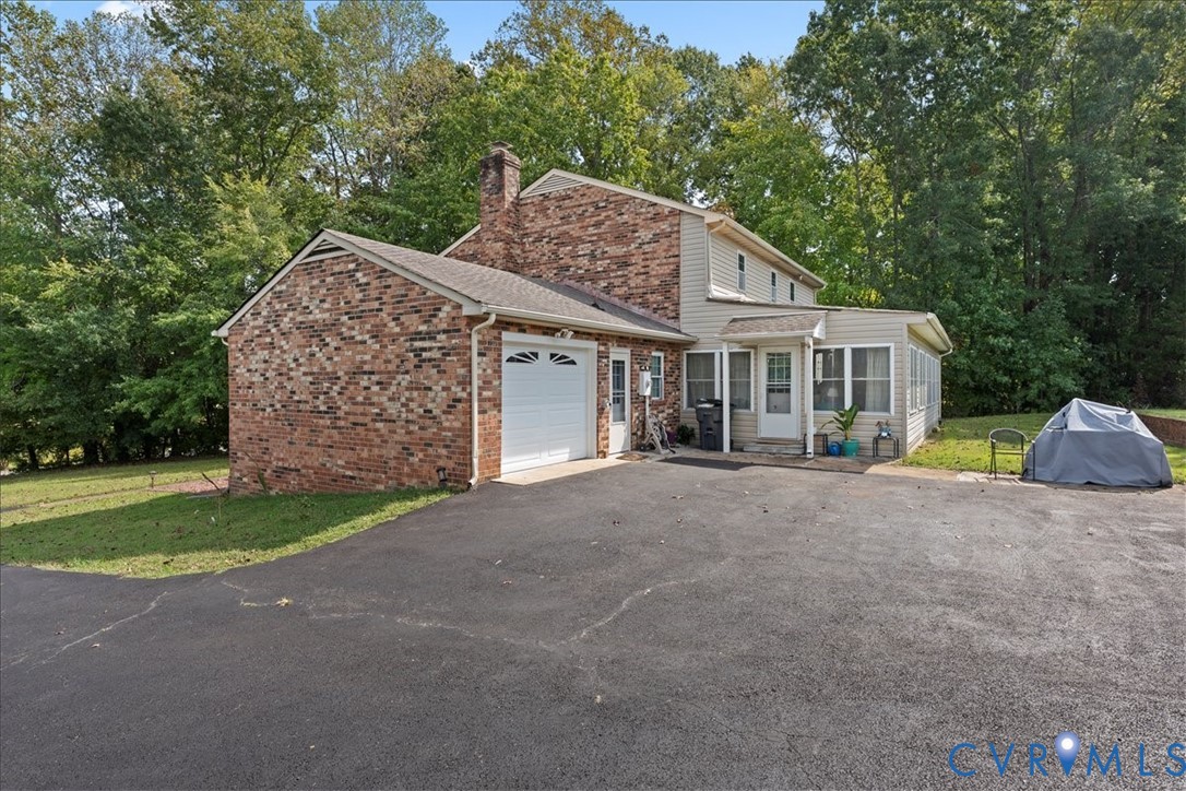 7141 Barkbridge Road Chesterfield, VA 23832 - Photo 5 of 44 View of front of house featuring a garage, asphalt