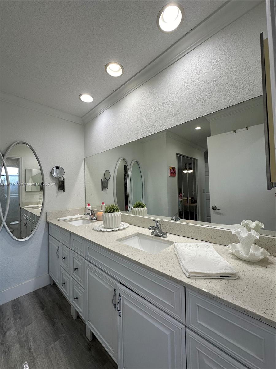 23304 Southwest 58th Avenue, Unit B Boca Raton, FL 33428 - Photo 14 of 32 a bathroom with a double vanity sink and a mirror