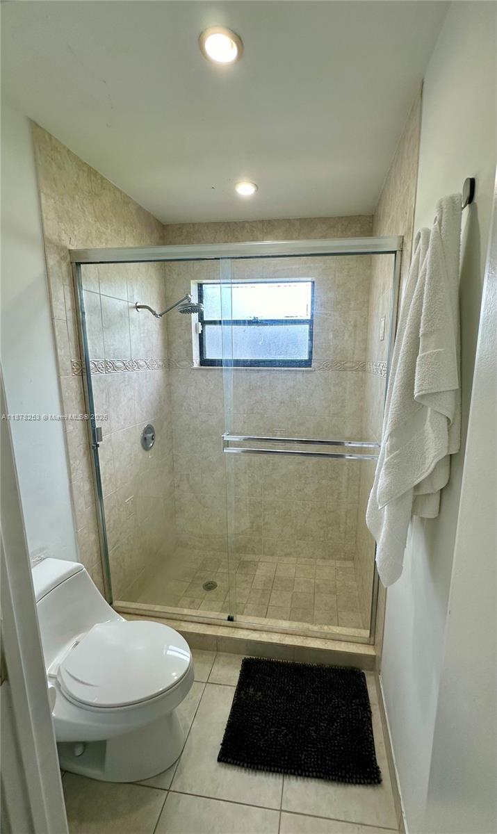 23304 Southwest 58th Avenue, Unit B Boca Raton, FL 33428 - Photo 15 of 32 a bathroom with a sink a toilet a shower and a mirror