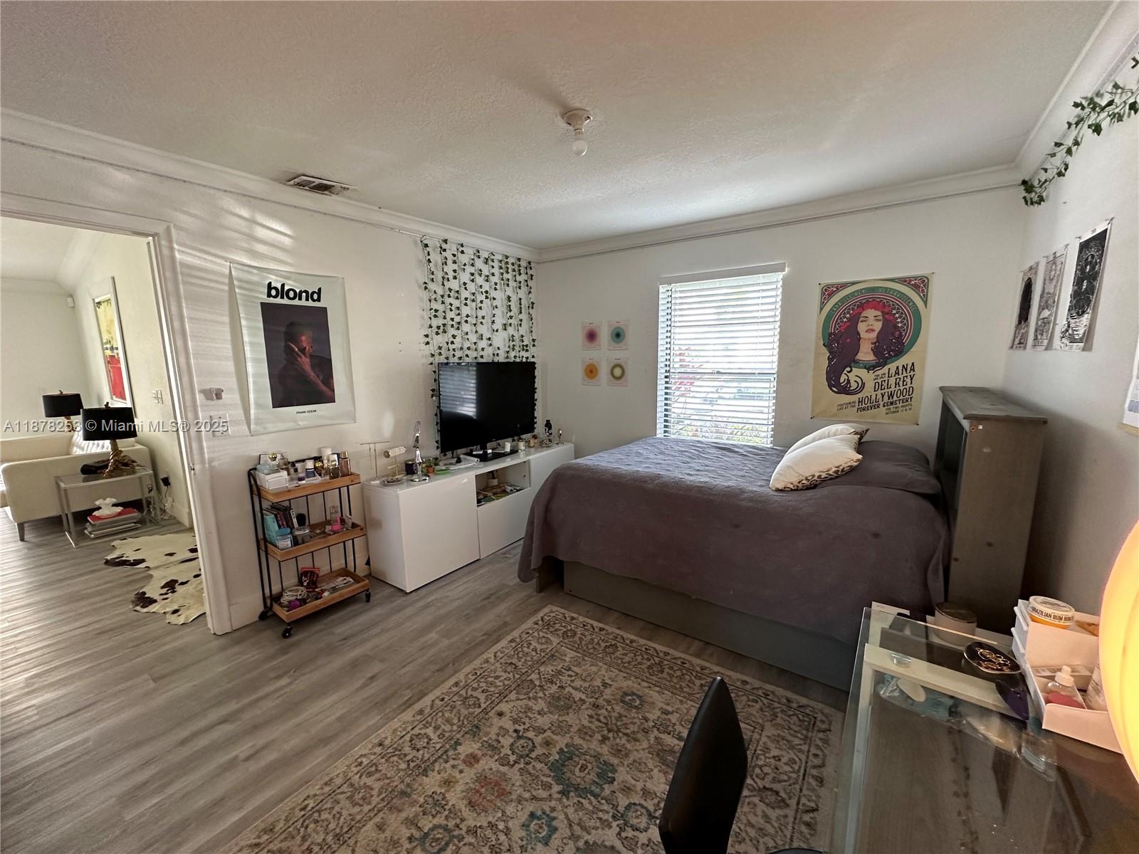 23304 Southwest 58th Avenue, Unit B Boca Raton, FL 33428 - Photo 16 of 32 a living room with furniture and a flat screen tv