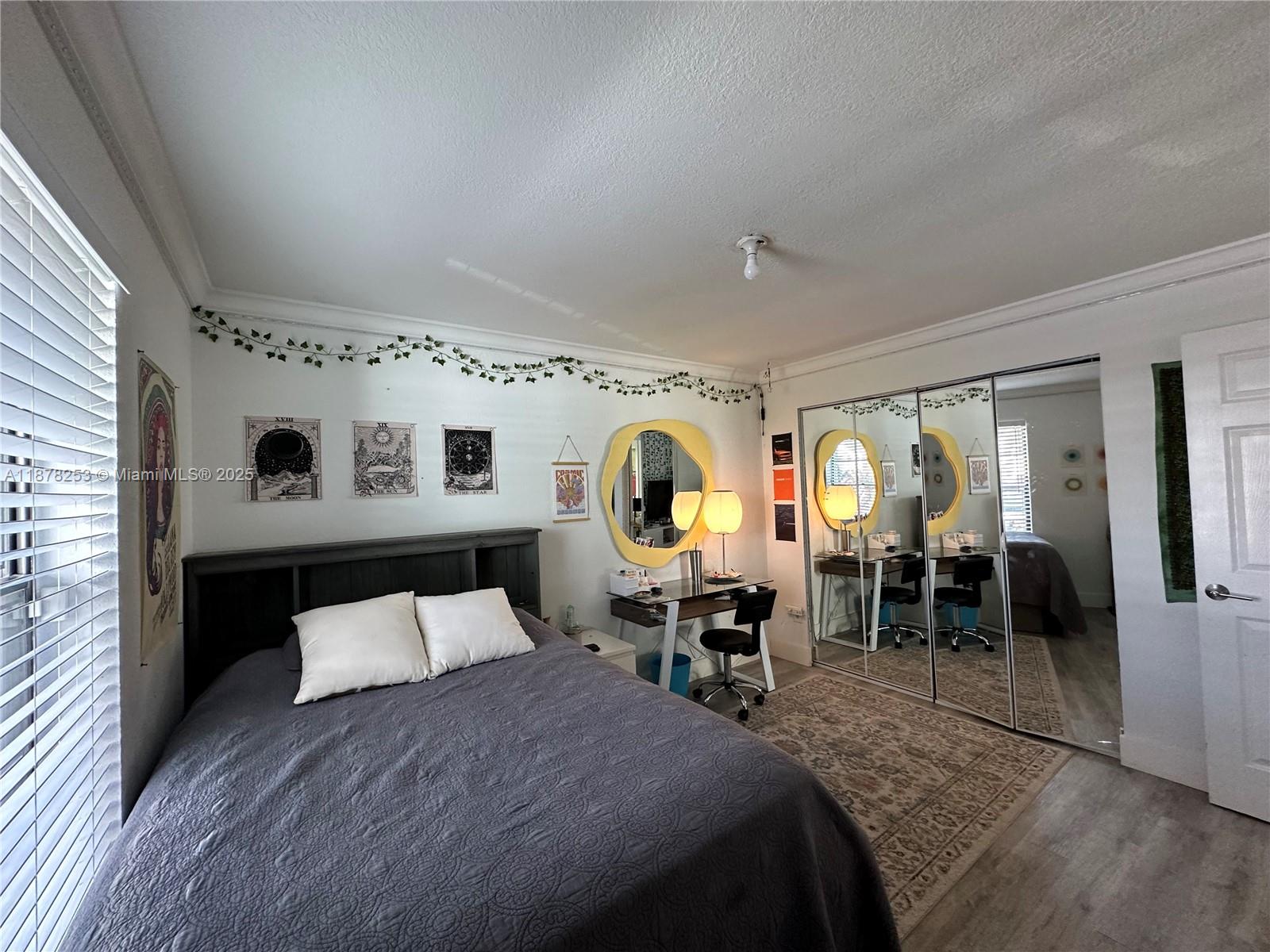 23304 Southwest 58th Avenue, Unit B Boca Raton, FL 33428 - Photo 17 of 32 a spacious bedroom with a bed and window