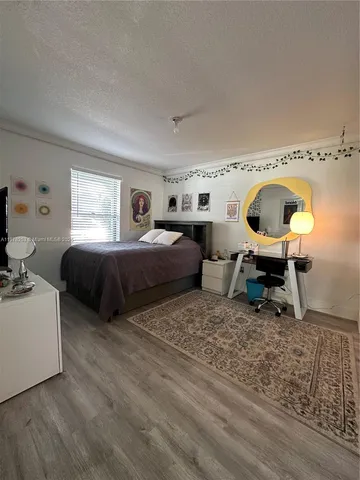 a living room with a bed furniture and a window