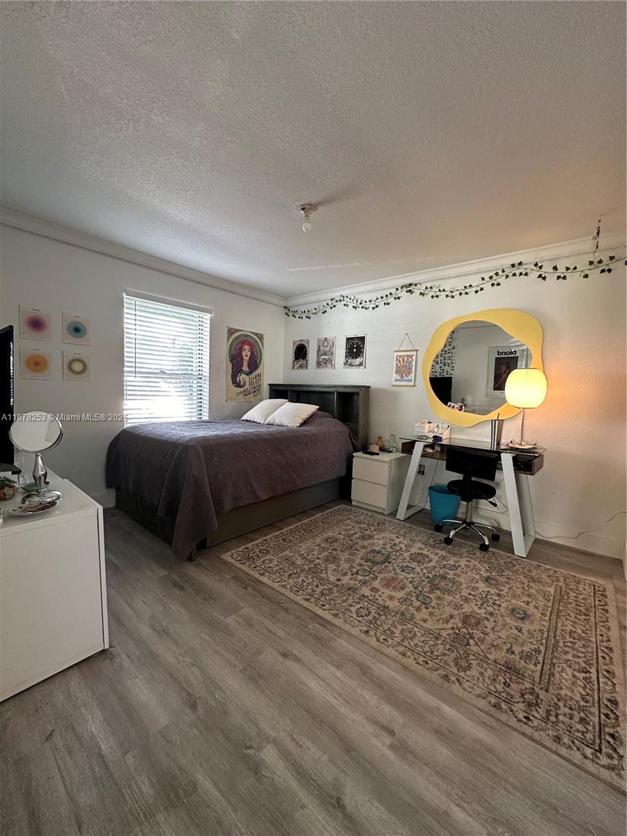 23304 Southwest 58th Avenue, Unit B Boca Raton, FL 33428 - Photo 18 of 32 a living room with a bed furniture and a window