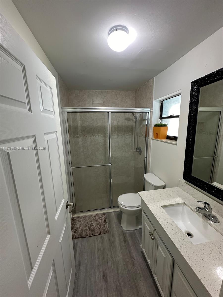 23304 Southwest 58th Avenue, Unit B Boca Raton, FL 33428 - Photo 20 of 32 a bathroom with a sink a toilet and shower