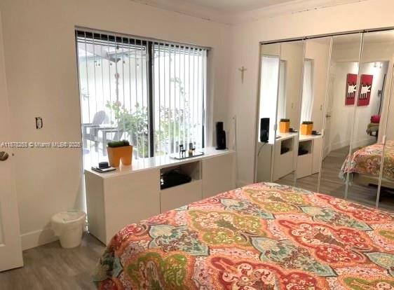 23304 Southwest 58th Avenue, Unit B Boca Raton, FL 33428 - Photo 22 of 32 a bedroom with a bed and a large window with outer view