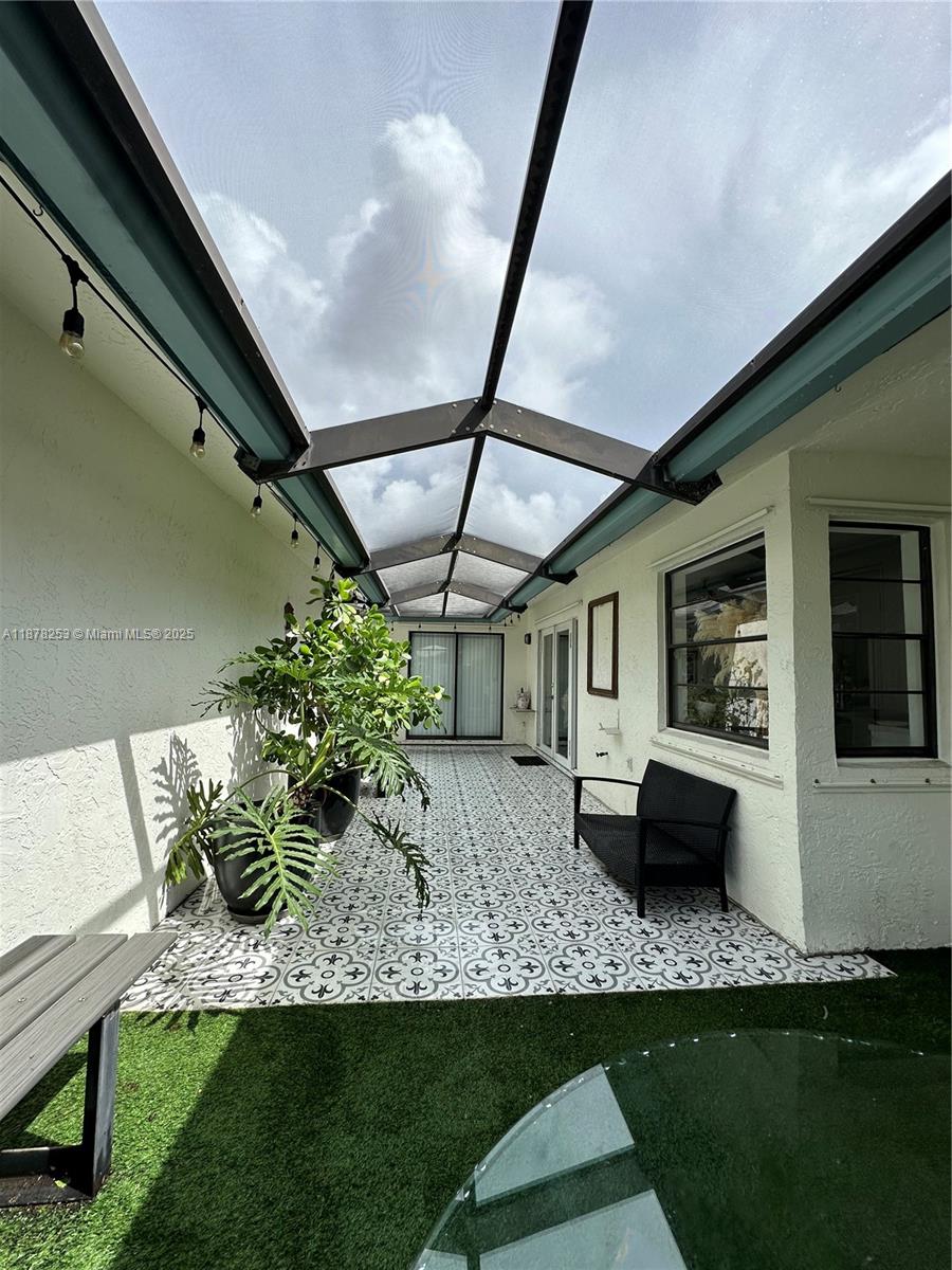 23304 Southwest 58th Avenue, Unit B Boca Raton, FL 33428 - Photo 24 of 32 a house view with a outdoor seating