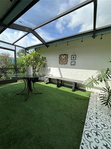 a view of backyard with a table and chairs