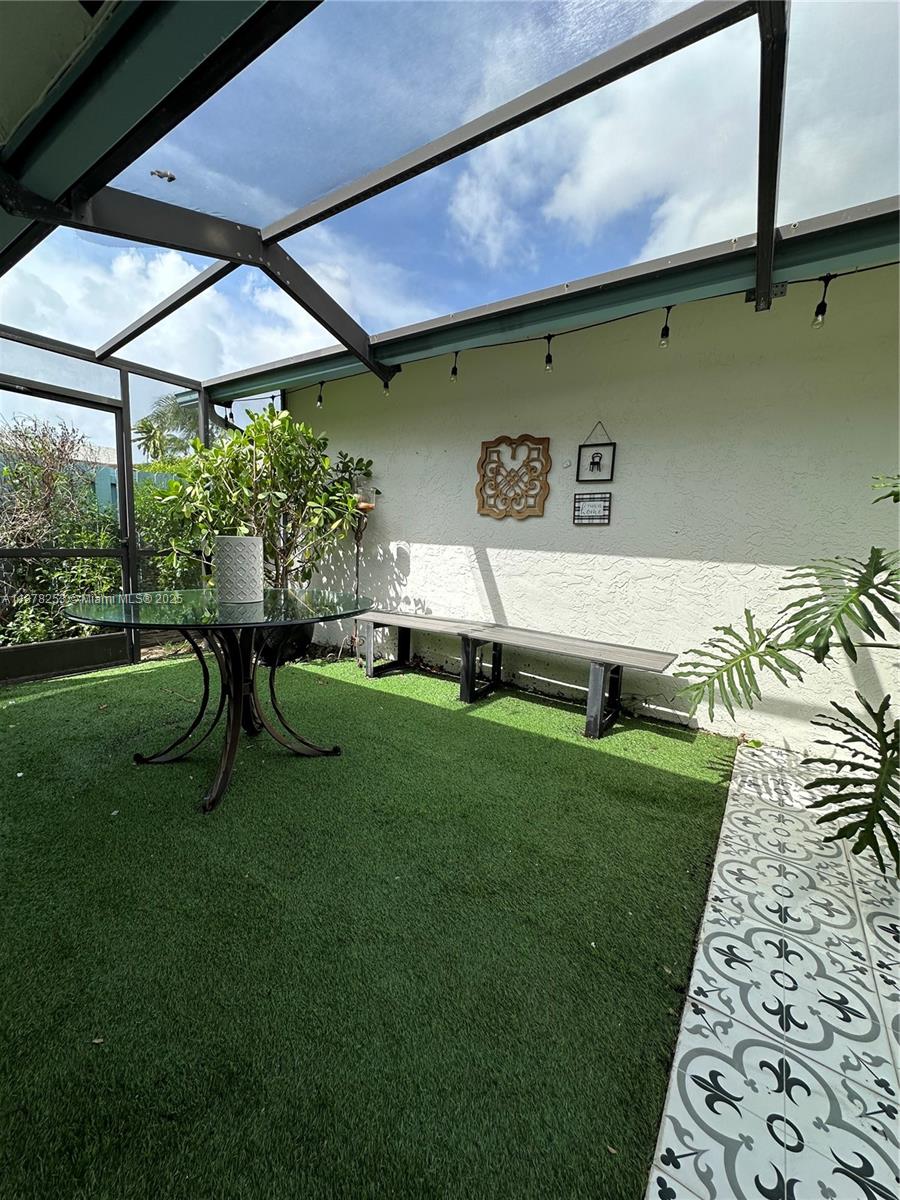 23304 Southwest 58th Avenue, Unit B Boca Raton, FL 33428 - Photo 25 of 32 a view of backyard with a table and chairs