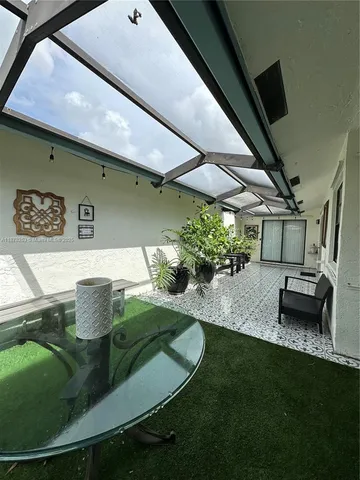 a backyard of a house with table and chairs