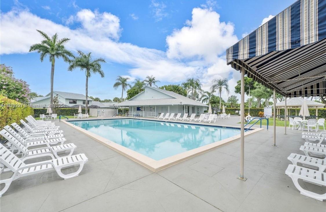 23304 Southwest 58th Avenue, Unit B Boca Raton, FL 33428 - Photo 30 of 32 a view of a swimming pool with a patio and a yard