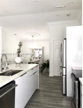 23304 Southwest 58th Avenue, Unit B Boca Raton, FL 33428 - Photo 4 of 32 a kitchen with a sink refrigerator and cabinets